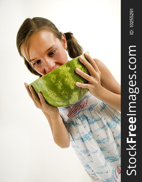 Young girl eating a watermelon isolated on a white background