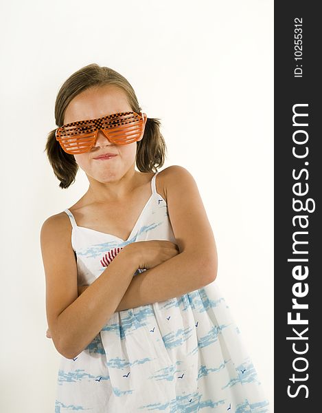 Young girl acting tough wearing goofy sunglasses, isolated on a white background. Young girl acting tough wearing goofy sunglasses, isolated on a white background.