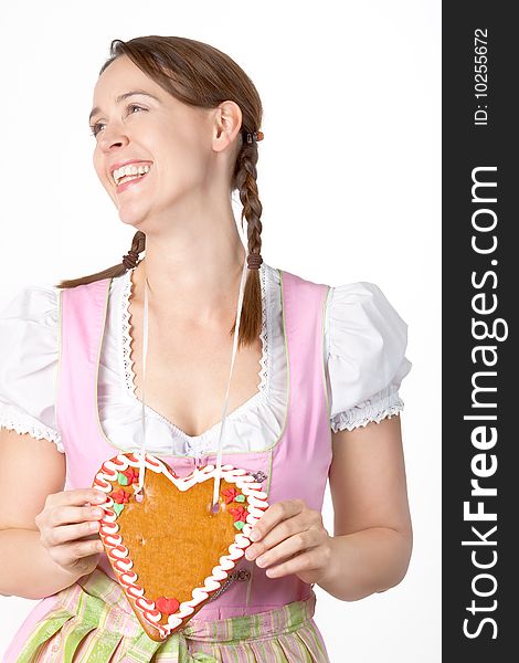 A young woman dressed in a traditional Bavarian Dirndl with a blank Herzl - on white. A young woman dressed in a traditional Bavarian Dirndl with a blank Herzl - on white