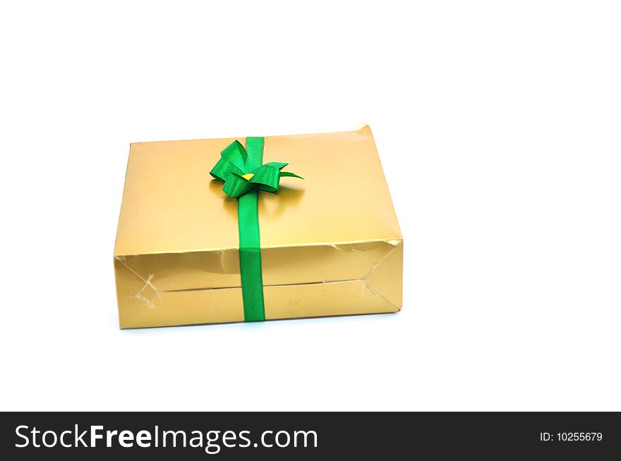 Gift box golden color with green bow.