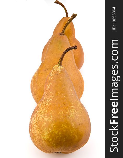 Three yellow pears, separately on white.