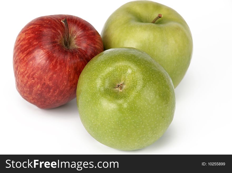 Three apples, green and red, it is photographed on a white background