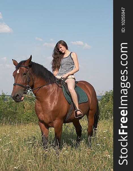 Girl sits on horseback