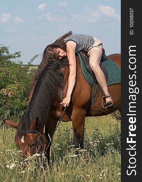 Girl lies on horseback