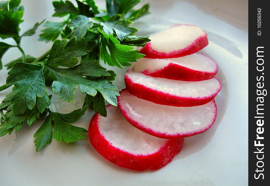 Cut garden radish and leaves of parsley