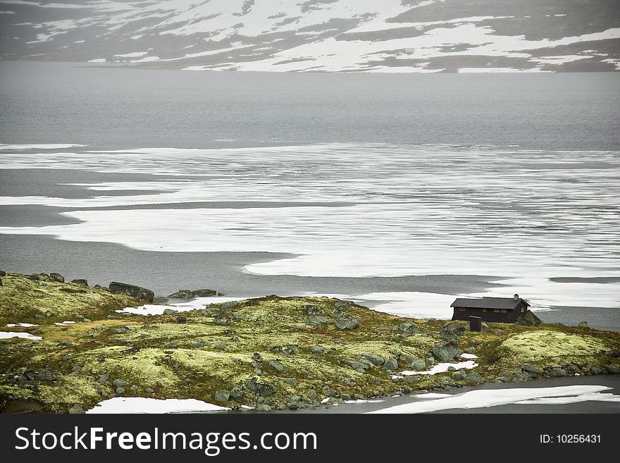 Small small house on the bank of high-mountainous lake. Summer. Norway. Small small house on the bank of high-mountainous lake. Summer. Norway