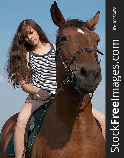 Girl Sits On Horseback