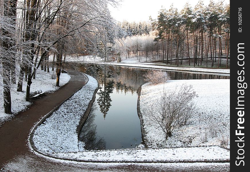 Winter park in the morning, pond in the middle parka