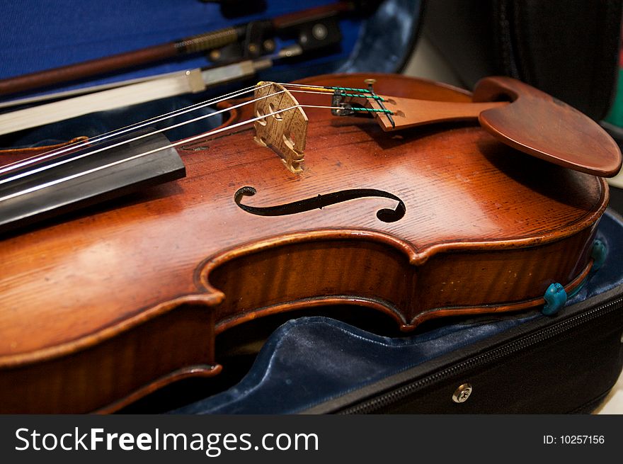 A violin in a case with its bow. A violin in a case with its bow