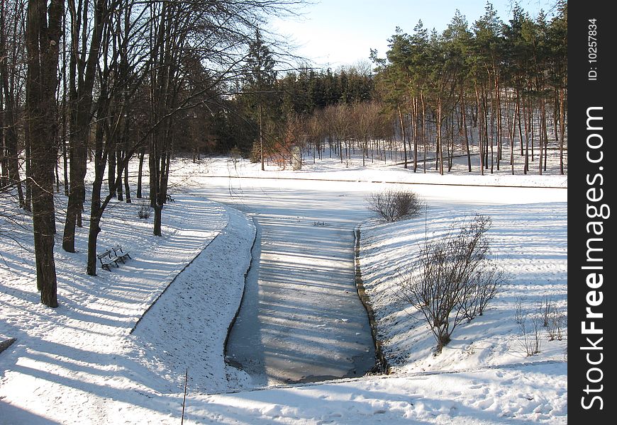 Winter park, the small river was covered ice. Winter park, the small river was covered ice