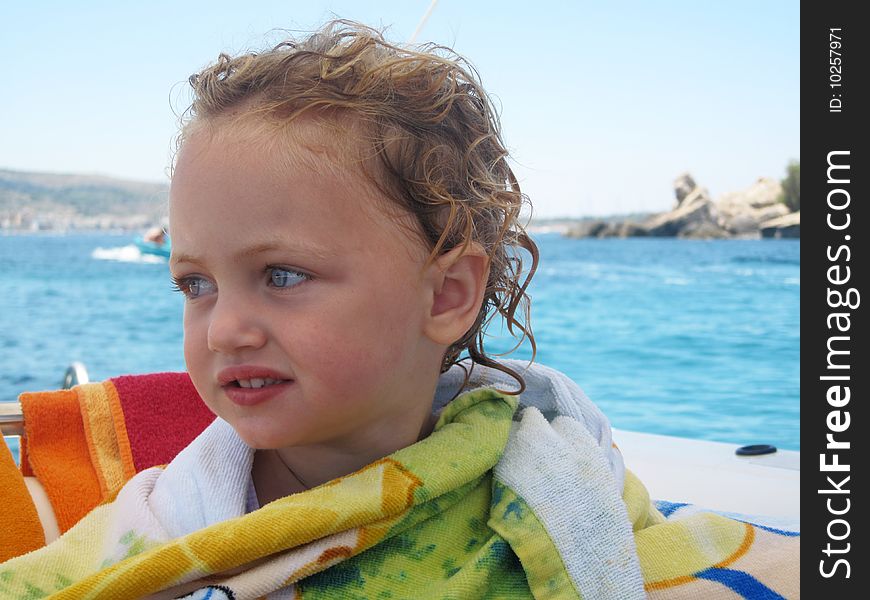 A young toddler cautious on a boat with a worried look on her face. A young toddler cautious on a boat with a worried look on her face