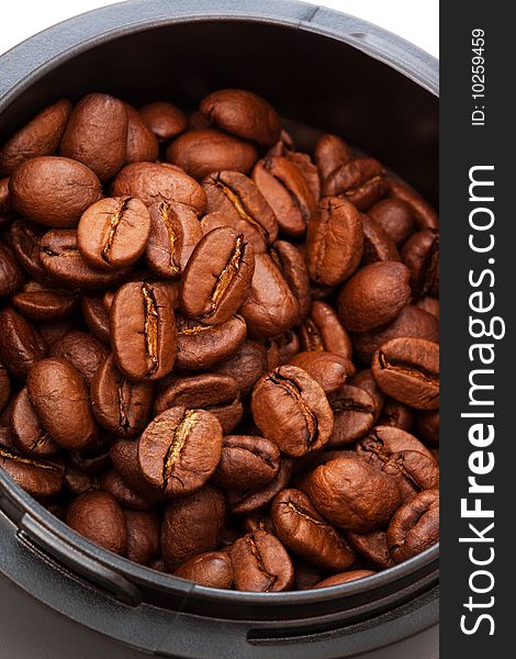 Roasted coffee beans grinders in close up