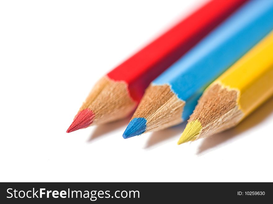 Close-up macro image of three wooden pencils representing the primary colors. Shallow depth of field. Close-up macro image of three wooden pencils representing the primary colors. Shallow depth of field.