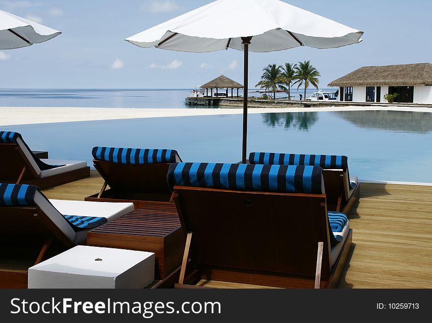 Sunshade and chairs at the pool. Sunshade and chairs at the pool