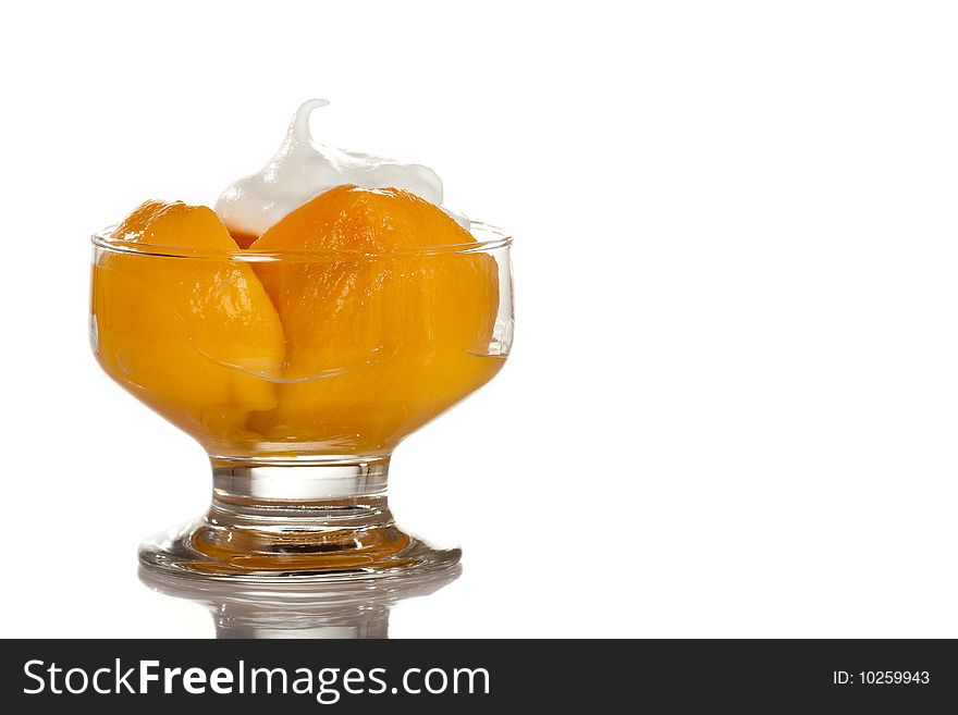 A beautiful cup of pieces of peach and cream of milk isolated on a white background. A beautiful cup of pieces of peach and cream of milk isolated on a white background