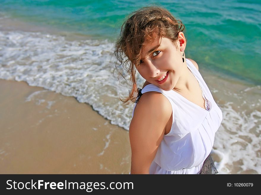 Beauiful girl in white dress on sea background