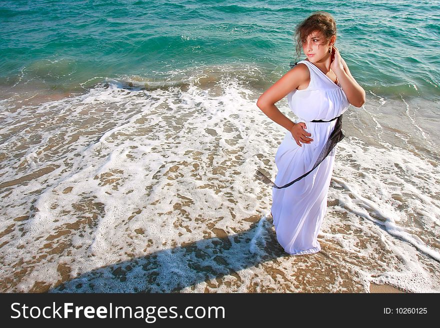 Beautiful girl standing on sea background. Beautiful girl standing on sea background
