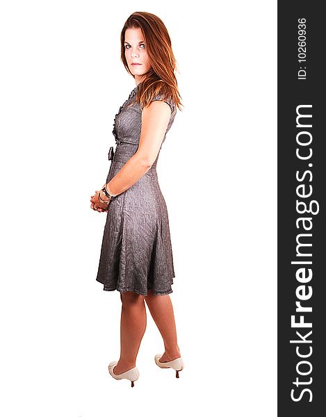 Young lovely girl in a gray dress looking back over her shoulder,
standing in the studio for white background. Young lovely girl in a gray dress looking back over her shoulder,
standing in the studio for white background.