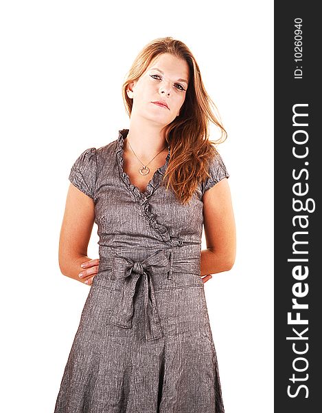 Young lovely girl in a gray dress looking strait in the camera, crossing her arms on the back, standing in the studio for white background. Young lovely girl in a gray dress looking strait in the camera, crossing her arms on the back, standing in the studio for white background.