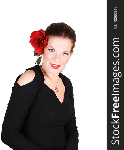 Young light red haired woman in an black dress standing in the studio 
for white background, with a big red rose in her hair. Young light red haired woman in an black dress standing in the studio 
for white background, with a big red rose in her hair.