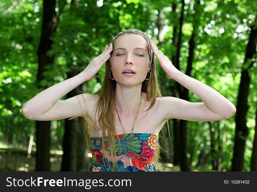 Young woman with closed eyes in summer park. Young woman with closed eyes in summer park