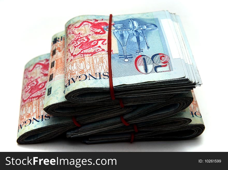 A lot of Singapore Dollars on white background.