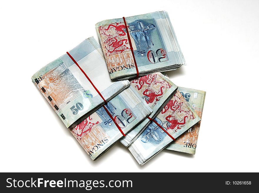 A lot of Singapore Dollars on white background.