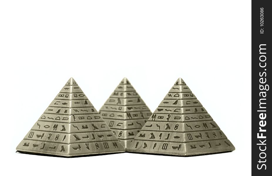 Metal Imitation Of Egyptian Pyramid Macro Isolated On White Background. Metal Imitation Of Egyptian Pyramid Macro Isolated On White Background