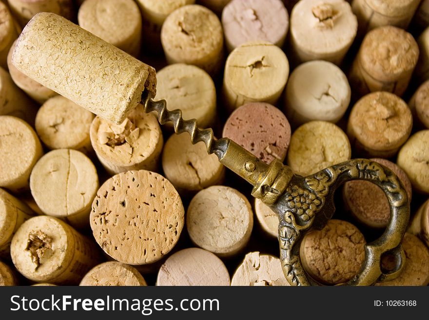 A closeup, detailed view on a stoppers from wine bottles, and old corkscrew. A closeup, detailed view on a stoppers from wine bottles, and old corkscrew