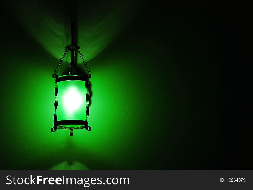 Green lamp over dark background. Green lamp over dark background