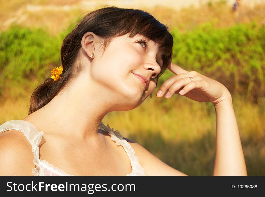 Women's sunset portrait on colored nature background. Women's sunset portrait on colored nature background