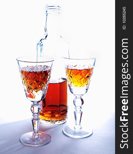 Color photo of a bottle and a glass of whiskey. Color photo of a bottle and a glass of whiskey