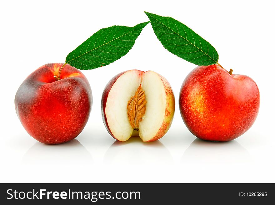 Ripe Sliced Peach (Nectarine) with Green Leafs Isolated on White Background