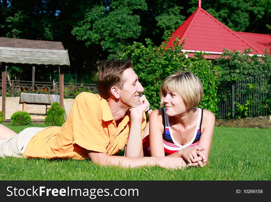 Young couple laying on grass. Young couple laying on grass