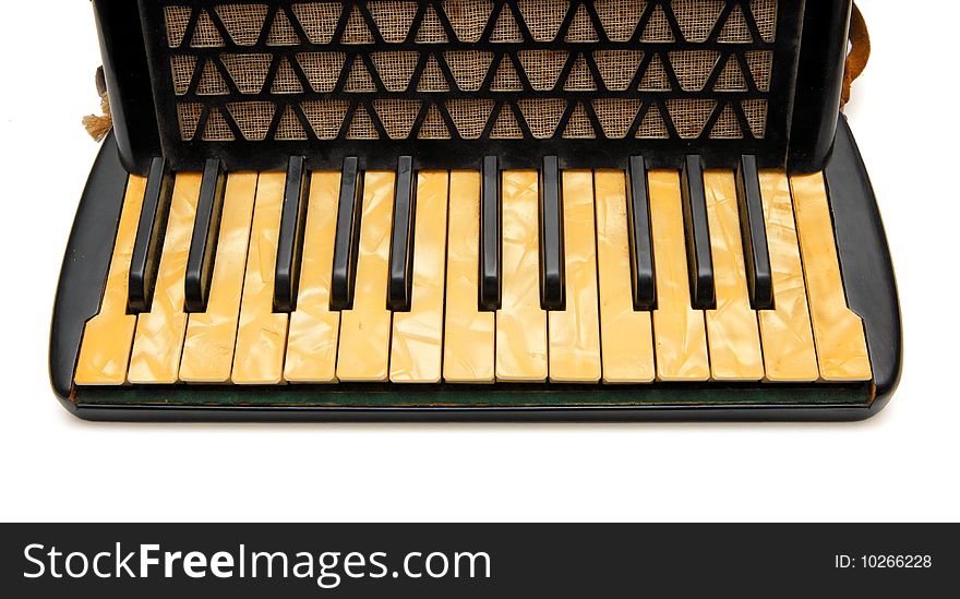 Keyboard of vintage 1930s black accordion closeup isolated on white