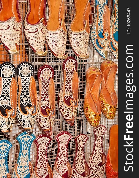 A display of very colourful and decorated shoes designed in the Arabic style. A display of very colourful and decorated shoes designed in the Arabic style