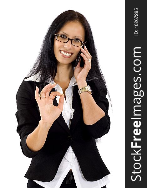 Attractive businesswoman on the phone making her ok sign. Attractive businesswoman on the phone making her ok sign