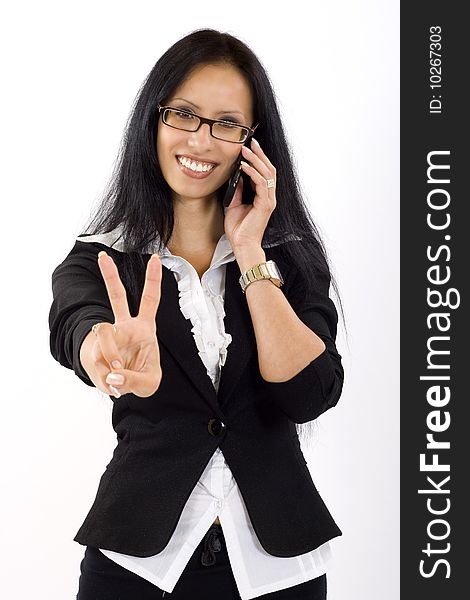 Attractive businesswoman on the phone making her victory sign. Attractive businesswoman on the phone making her victory sign