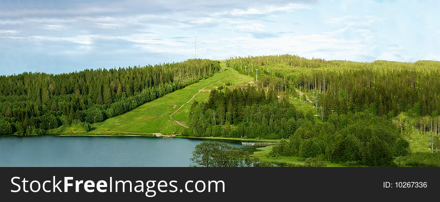 Green big hills with a lake