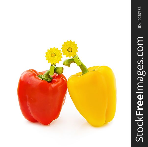 Healthy eating - fresh red and yellow pepper with wooden flower clip isolated on white background. Healthy eating - fresh red and yellow pepper with wooden flower clip isolated on white background.