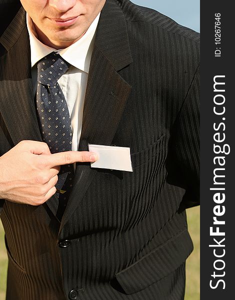 Businessman pointing on empty card with his finger