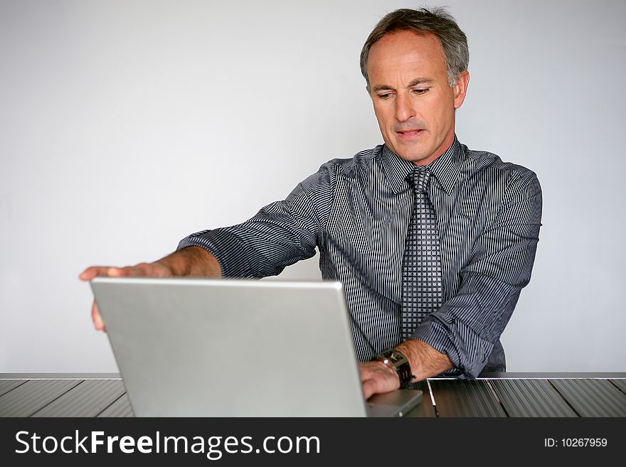 Businessman at desk using laptop
