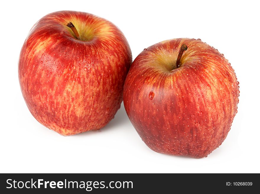 Two red apples with water drops, it is photographed on a white background