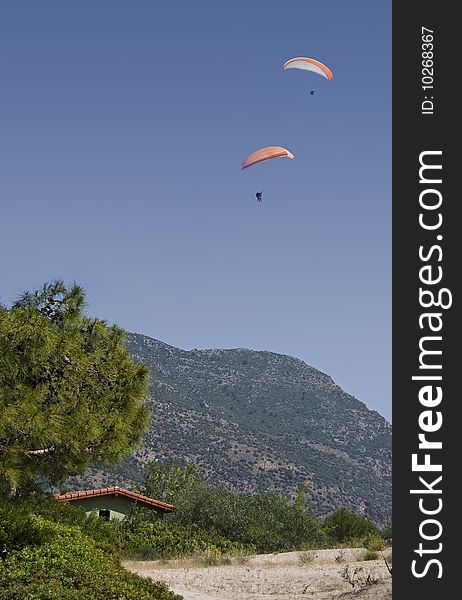 Two paragliders drift over the Turkish resort of Olu Deniz. Two paragliders drift over the Turkish resort of Olu Deniz