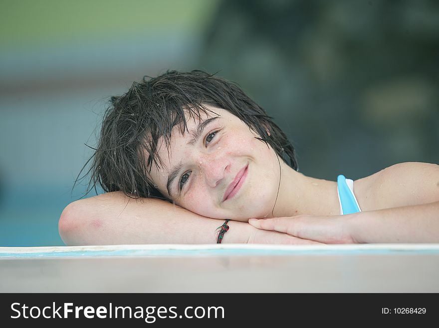 Portrait of happy girl in swimmingpool
