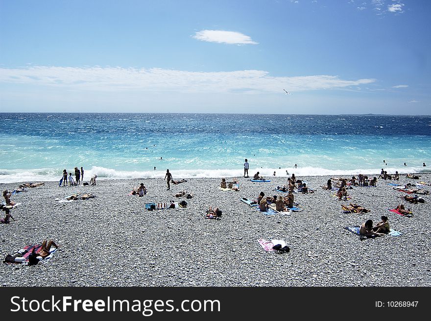 Beach with people in summer time in Nice