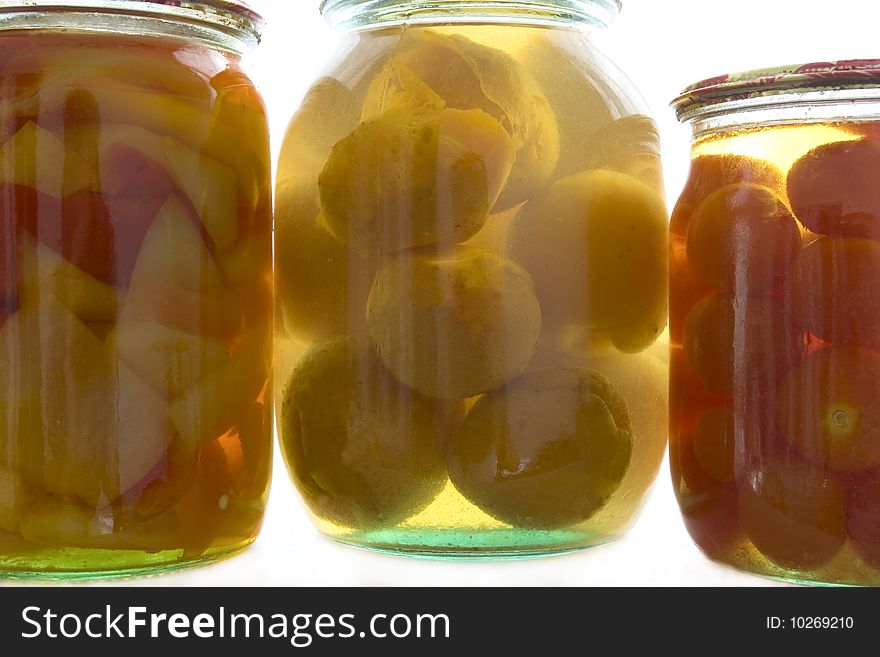 Glass with the preserved tomatoes, apricot, paprika, pepper