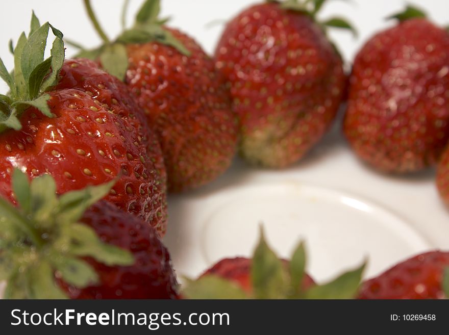 Fresh and tasty strawberries on white plate