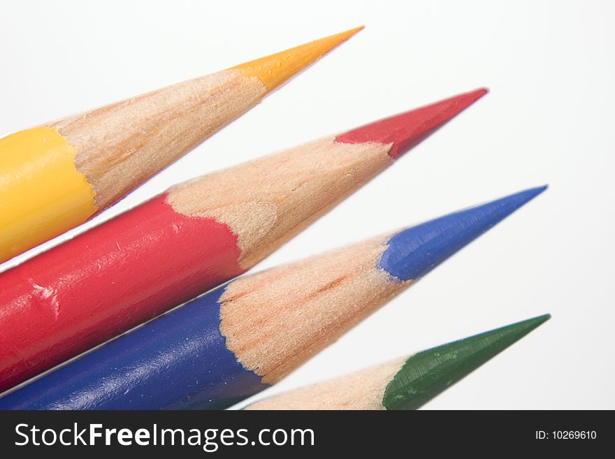 Close up of blue, yellow, red, and green sharp colored pencils. Close up of blue, yellow, red, and green sharp colored pencils