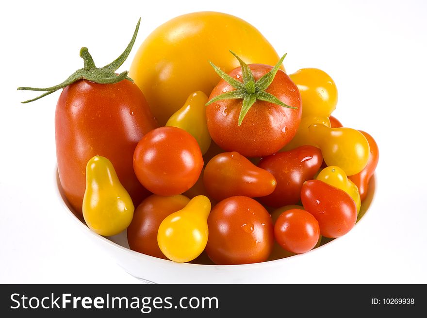 Roma, red pear, yellow pear, lemon boy, and cherry tomatoes fill a small bowl. Roma, red pear, yellow pear, lemon boy, and cherry tomatoes fill a small bowl.